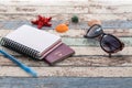 Travel concept: passport, sunglasses, notebook, and seashells si Royalty Free Stock Photo