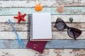 Travel concept: passport, sunglasses, notebook, and seashells to Royalty Free Stock Photo