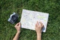 Travel concept photo with map of old european town and woman`s finger and old camera Royalty Free Stock Photo