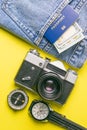 Travel concept with retro camera, passport, money, compass, clock. Outfit of traveler on yellow background, Tourist essentials.Top Royalty Free Stock Photo