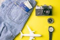 Travel concept with retro camera, passport, money, compass, clock, toy plane. Outfit of traveler on yellow background, Tourist Royalty Free Stock Photo