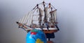 Travel Concept Stock Photo. Blurred Globe In Front Of Wooden Model Of Old Ship Royalty Free Stock Photo