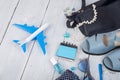 blue bag, sunglasses, sandals, nail polish, earphone note pad and little airplane on white wooden background Royalty Free Stock Photo