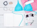 summer women& x27;s fashion with blue swimsuit, book, pink towel, cos Royalty Free Stock Photo