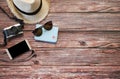 Travel concept . Top view of tourist accessories  on wooden table background camera ,hat ,passport, mobile phone,sunglasses. Royalty Free Stock Photo