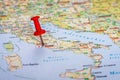 Travel concept, tourist trip. On the map of Italy, the Vatican is marked with a red pushpin. Selective focus Royalty Free Stock Photo