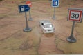 Travel concept. Toy car on vintage World map with road sign