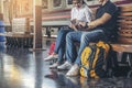 Travel concept.At train station,Young Tourists Couple of Love  pointing and planning happy holiday vacation.Asian Backpacker Royalty Free Stock Photo