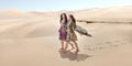 Travel concept. Two gordeous women sisters traveling in desert. Arabian Indian movie stars. Royalty Free Stock Photo