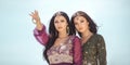 Travel concept. Two gordeous women sisters traveling in desert. Arabian Indian movie stars.