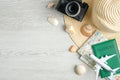 Travel concept on wooden table. Top view retro style camera, beach hat, passport document, map, airplane model and seashells. Royalty Free Stock Photo