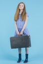 Travel Concepts. Full Length Portrait of Caucasian Teenage Girl In Long Blue Dress, Wellington Rubber Boots Posing With Travel Royalty Free Stock Photo
