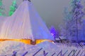 Travel Concepts and Ideas. Marvelous Lapland Houses in Suomi Village in Front of Marvelous Highlighted Winter Forest Scenery