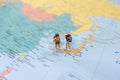 Travel Concepts. A little figure couple backpacker or miniature couple tourist male and female stand and walk on map of Japan in