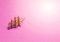 Travel Concepts. Scale Model of Three-Masted Sail Boat Placed Over Pink Background Royalty Free Stock Photo