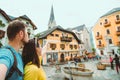 travel couple in hallstatt austria point straight ahead