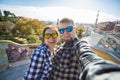 Travel couple happy making selfie portrait with smartphone in Park Guell, Barcelona, Spain. Royalty Free Stock Photo