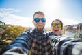 Travel couple happy making selfie portrait with smartphone in Park Guell, Barcelona, Spain. Royalty Free Stock Photo