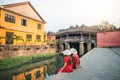 Travel couple with Japanese Covered Bridge, in Hoi An, Vietnam