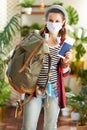 Young solo traveller woman in modern house in sunny day