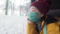 Travel during covid19 - young happy and beautiful Asian Japanese woman in face mask looking to snow through train window traveling Royalty Free Stock Photo