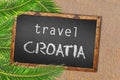 Travel Croatia palm trees and blackboard on sandy beach Royalty Free Stock Photo