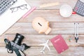 Travel desk with piggy bank for savings, passport and airplane Royalty Free Stock Photo