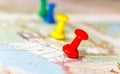 Travel destination points on a map indicated with colorful thumbtacks and shallow depth of field with space for copy