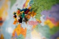 Travel destination points on a map indicated with colorful thumbtacks and shallow depth of field with space for copy