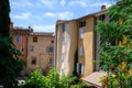 View on rows of blossoming purple lavender, green fiels and Lacoste village in Luberon, Provence, France in July