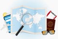 Travel destination Spain, tourism mockup with travel equipment and world map with magnifying glass on a Spain
