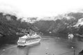 Travel destination, tourism. Cruise ship in norwegian fjord. Passenger liner docked in port. Adventure, discovery Royalty Free Stock Photo