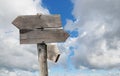 travel destinations options. Direction road sign with wooden arrows on sky and clouds