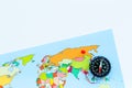 Travel direction and trip planning concept with compass and map of the world on white background top view space for text Royalty Free Stock Photo