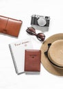 Travel dreams, stay at home. Travel background - passport, straw hat, sneakers, sunglasses and vintage camera on a light Royalty Free Stock Photo