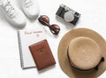 Travel dreams, stay at home. Travel background - passport, straw hat, sneakers, sunglasses and vintage camera on a light