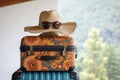 Travel essentials retro hat, sunglasses, and luggage on isolated space