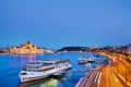 Travel and european tourism concept. Parliament and riverside in Budapest Hungary with sightseeing ships during blue hour sunset