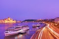 Travel and european tourism concept. Parliament and riverside in Budapest Hungary with sightseeing ships during blue hour sunset
