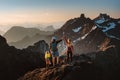 Travel family hiking in Norway climbing mountains expedition active vacations parents and child on summit Royalty Free Stock Photo