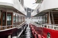 Travel ferries in red and dark red side by side at the port.