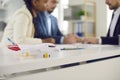 Airplane model on desk and multi-ethnic couple signing insurance contract