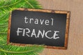 Travel France palm trees and blackboard on sandy beach Royalty Free Stock Photo