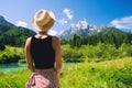 Travel, Freedom, Lifestyle concept. Young woman enjoying green nature outdoors. Amazing view on Zelenci into English means -