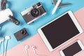 Travel gadgets on blue and pink background for travel concept Royalty Free Stock Photo