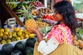 Travel girl seller in street market and a buyer in a fruit shop in india delhi.smiling business woman indonesian in Royalty Free Stock Photo