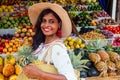 Travel girl seller in street market and a buyer in a fruit shop in india delhi.smiling business woman indonesian in Royalty Free Stock Photo