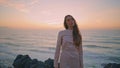 Travel girl walking evening hill at ocean view. Serene woman looking camera Royalty Free Stock Photo