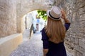 Travel In Greece. Back View Of Tourist Girl Visiting The Old Town Of Rhodes, Greece