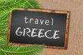 Travel Greece palm trees and blackboard on sandy beach Royalty Free Stock Photo